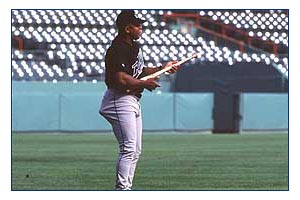 A Devil Rays player plays his bat like a guitar